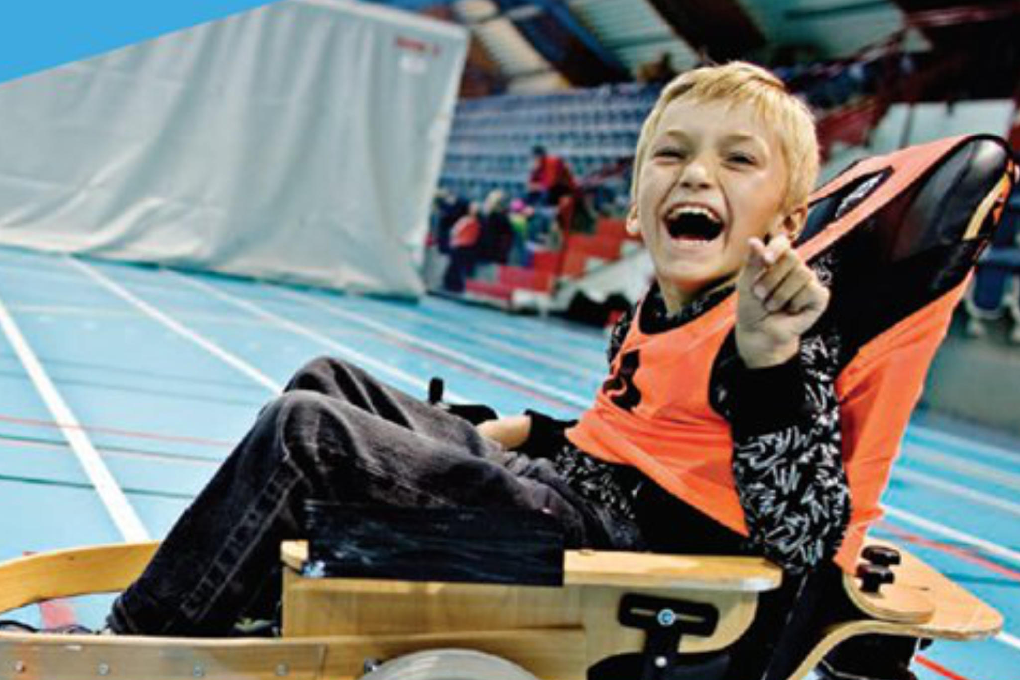 Boy playing volt hockey and smiling at camera