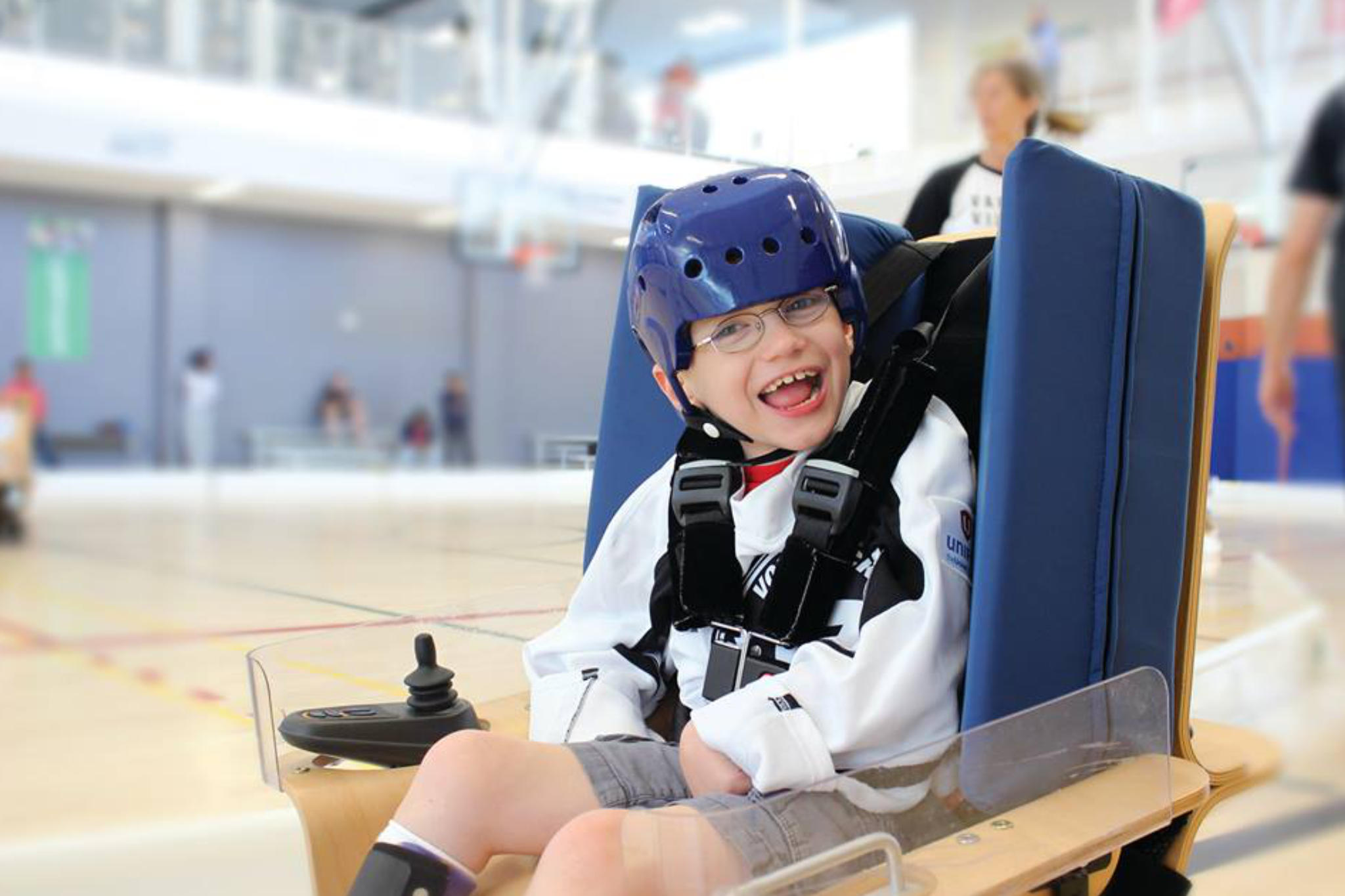 Boy playing Volt Hockey and smiling at camera